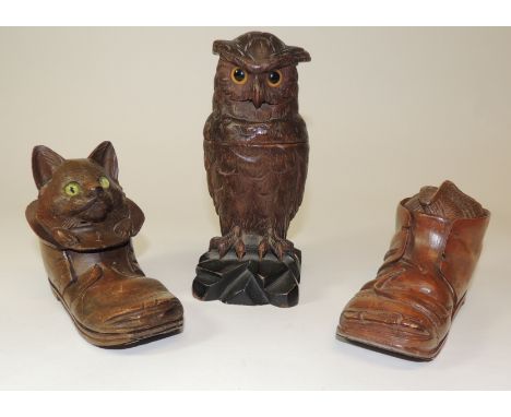 A late 19th Century Black Forest carved owl inkwell with inset glass eyes and fitted with original well and metal cover (lack