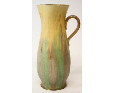 An early 20th Century Watcombe Pottery pitcher.  With pinched spout and a multi-coloured street glaze running vertically.  30