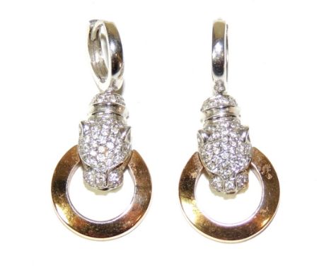 A pair of pierced white and yellow gold earrings, marked 18ct, in the form of a white sapphire encrusted leopard's head, with