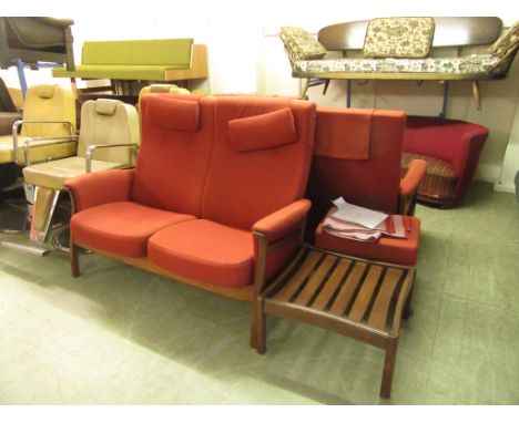 An Ercol teak and upholstered lounge suite including two two-seater sofas and two matching footstools CONDITION REPORT: Image