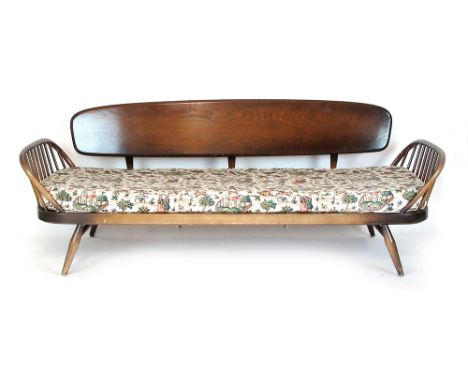 Lucien Ercolini for Ercol, a stained elm sofa bed with spindle arms and a surfboard back CONDITION REPORT: Webbing in good co