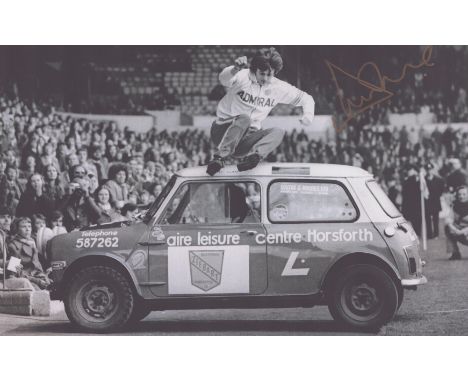 Autographed DUNCAN McKENZIE 12 x 8 photo : B/W, depicting a wonderful image showing Leeds United's DUNCAN McKENZIE jumping ov