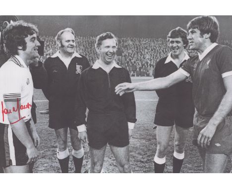 Autographed LOU MACARI 12 x 8 photo : B/W, depicting Manchester United captain LOU MACARI and his Liverpool counterpart Emlyn