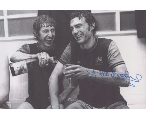 Autographed TREVOR BROOKING 12 x 8 photo : B/W, depicting West Ham United's Pat Holland and TREVOR BROOKING celebrating in th