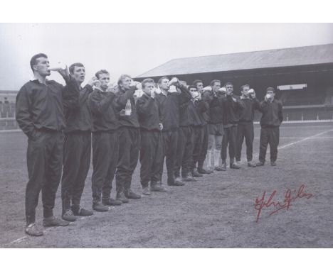 Autographed JOHN GILES 12 x 8 photo : B/W, depicting Manchester United players standing shoulder to shoulder as they drink mi