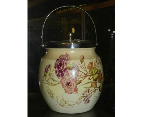 A Carlton ware biscuit barrel, decorated with flower on a blush ground.
