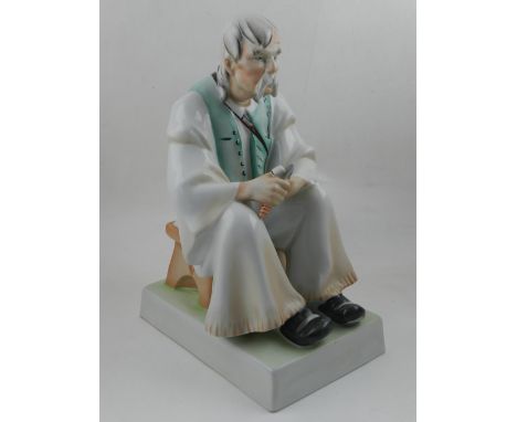A large Zsolnay porcelain model of a seated elderly shoemaker. H. 33cm