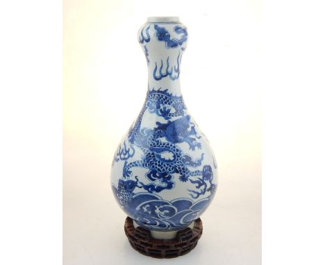 A Chinese blue and white garlic head vase, decorated with dragons chasing a flaming pearl amongst stylised clouds, bears seal