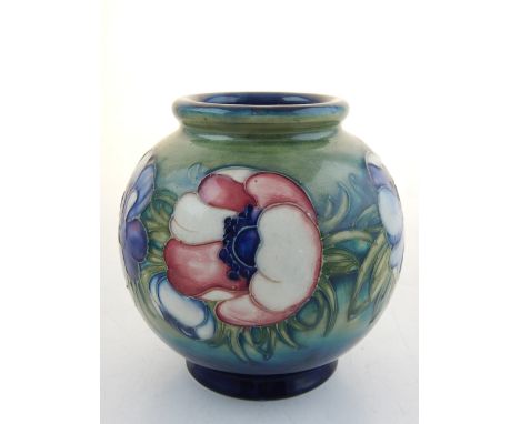 A Moorcroft globe shaped vase, anemone pattern with stamp and signature to base, H. 15cm.