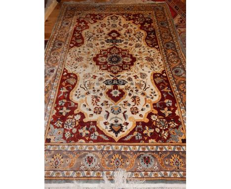 A Chinese silk carpet, stepped floral medallion to centre, foliate cream ground and grey borders,  290x177cm. 