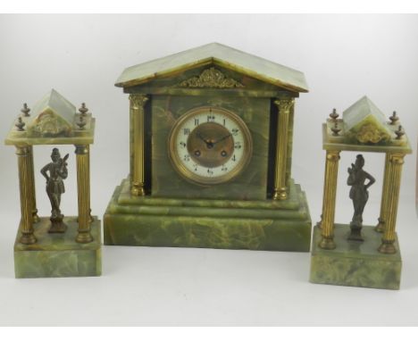 A 19th century gilt metal and onyx clock garniture, the clock of architectural form, having an Arabic enamelled dial flanked 