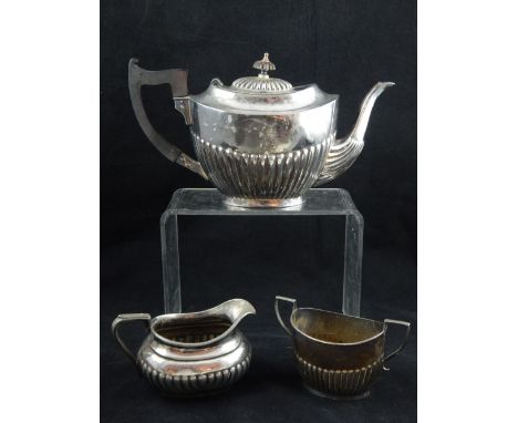 A George V demi fluted silver sugar bowl together with a similar silver plated teapot and cream jug