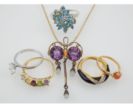 An amethyst and split seed pearl pendant, together with a quantity of yellow metal rings, and a silver and topaz cluster ring