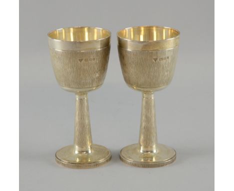 Pair of modern silver goblets with bark effect decoration, by Garrard & Co. Ltd., London, 1973, 14.7oz, 457g,