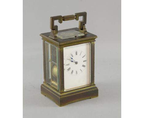 Brass and four glass repeating carriage clock with lever movement, the white enamelled dial with Roman numerals, 19cm high,