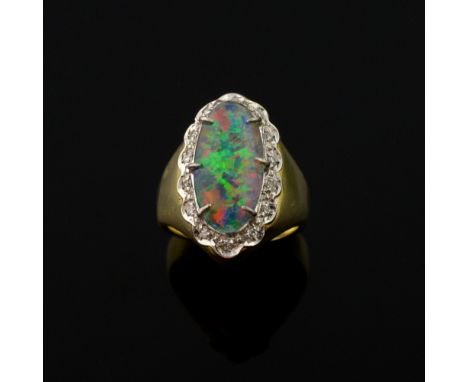  Opal and diamond dress ring, set with an oval opal doublet within a border of diamonds, gold tests as 14ct plus   