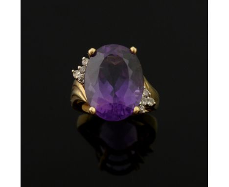 Amethyst and diamond dress ring, with oval  cut amethyst of 12 carats and diamond set shoulders, in unmarked yellow metal 