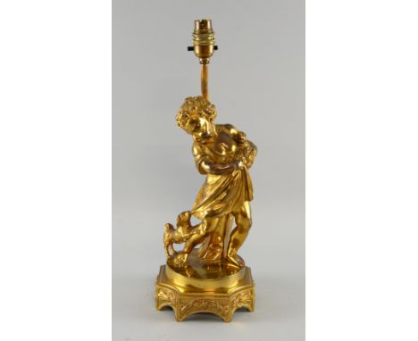 A gilt metal figural lamp of a child with two dogs.