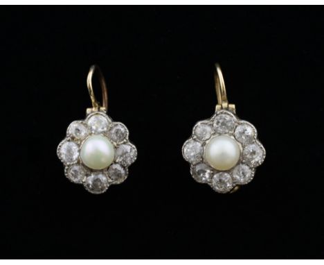 A pair of Early 20th C pearl and diamond cluster earrings, set with a pearl to the centre with a surround of eight old-cut di