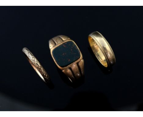  Signet ring and wedding bands, signet ring set with bloodstone, 15 ct and two wedding bands one with engraved decoration, 9 