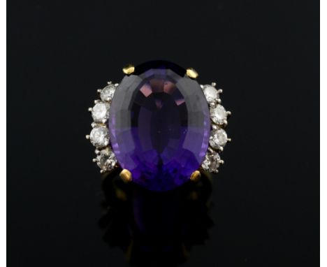 Amethyst and diamond ring, oval-cut amethyst weighing approximately 16.00 carats flanked by four round brilliant-cut diamonds