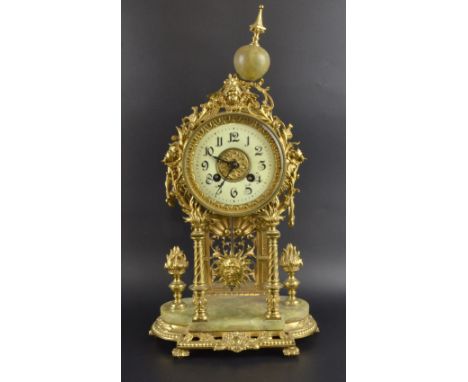 Gilt metal and onyx mantel clock with twin train movement striking on a bell.  Height 40cm.