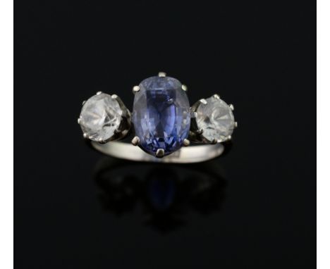 Sapphire set ring, central sapphire and two paste stones, in 18 ct white gold 