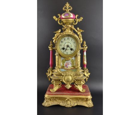 Gilt metal and porcelain mounted mantel clock with twin train movement.  42cm high.