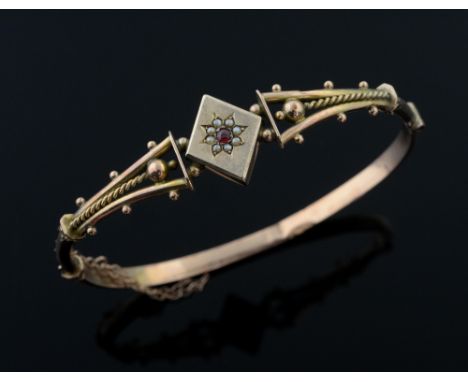 Edwardian gold and pearl hinged bangle set with seed pearls and red stone, stamped 9 ct 