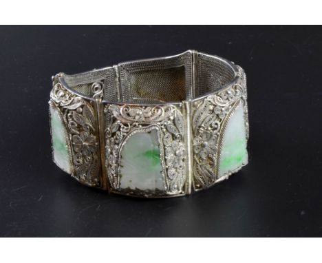 Chinese silver panel bracelet, with carved jade panels within a filigree mount  