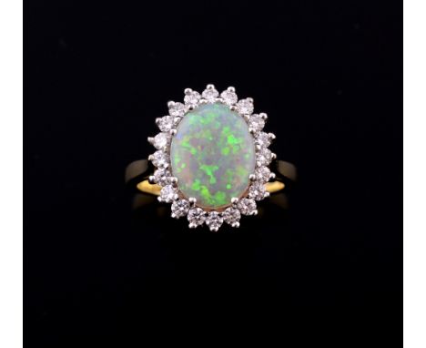 Opal and diamond cluster ring, with cabochon cut opal to the centre within  a border of twenty round-brilliant cut diamonds i