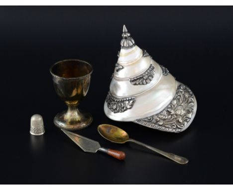  White metal mounted sea shell with scrolling floral decoration,  thimble, Birmingham, 1902, in fitted case, egg cup, spoon, 