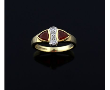 Fire opal and diamond dress ring, two trilliant cut fire opal with a centre row of diamonds. mounted in 18ct yellow gold. 