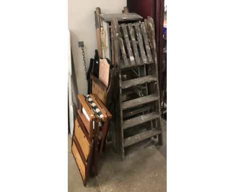 Three sets of pine folding step ladders, two folding chairs, a stool, etc.