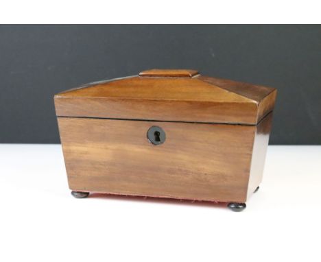 19th Century mahogany tea caddy of sarcophagus form, the lid opening to two lidded compartments with felt-lined interiors, wi