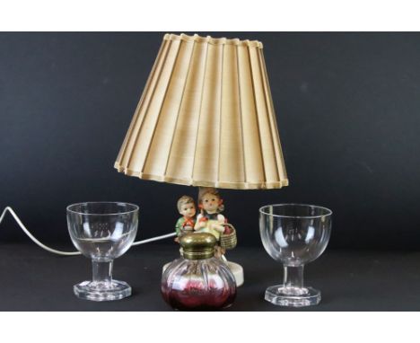 Large cranberry and colourless glass brass topped scent bottle, two large glass goblets and a Goebel Hummel table lamp, signe