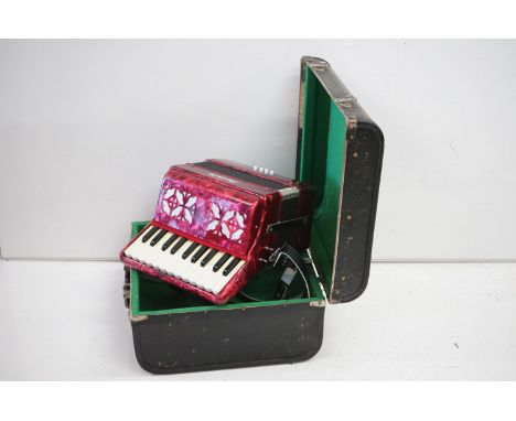 Scarlatti accordion having 22 keys and 8 base keys with a red case. Set within original leather case. Measures 26cm wide. 