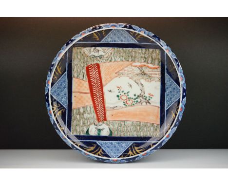 Japanese 19th Century ceramic dish having panelled decoration and gilt details. Mark to base. Measures 32cm diameter. 