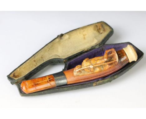 Late 19th Century meershaum pipe having a carved figure to the front and amber cheroot. Measures 12.5cm. In original leather 