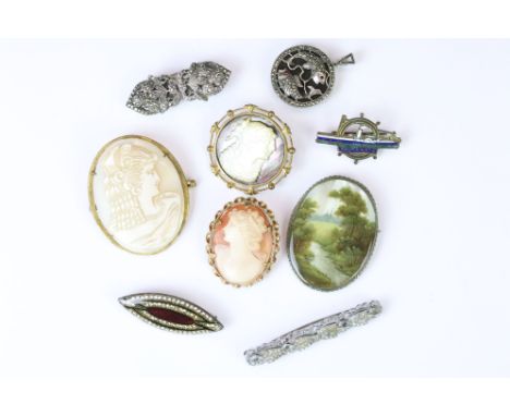 Three cameo brooches including one carved mother of pearl example, a hand painting mother of pearl brooch decorated with a a 