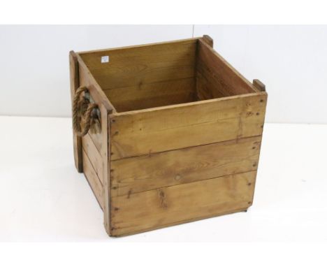 A vintage pine log box with rope handles 