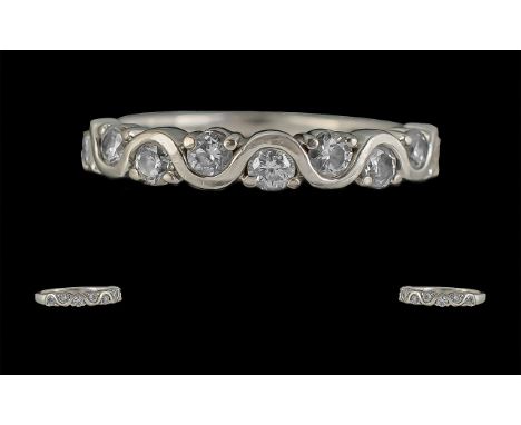 18ct White Gold Diamond Set Eternity Ring, the attractive wave band set with nine round cut diamonds.  Diamond weight 0.50ct,