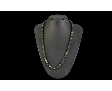 Nephrite Bead Necklace, comprising smooth, round beads of the rich, deep green spinach jade, individually knotted, fastening 