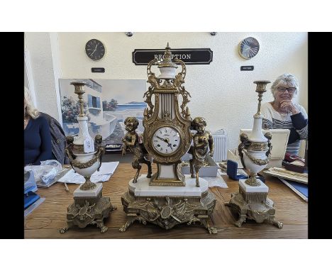 Italian Style Garniture Set, brass clock with white face and Roman numerals, two winder holes, in elaborate setting with a fi