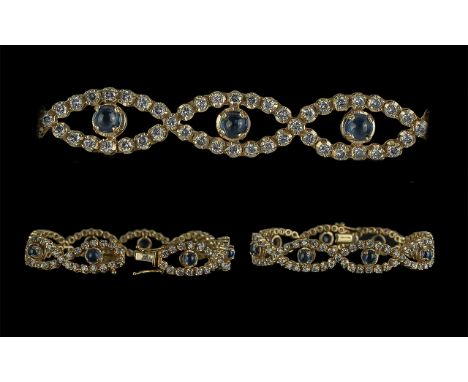 Ladies 14ct Gold Attractive Diamond and Sapphire Set Figure-of-Eight Design Bracelet, marked 14ct, the diamonds of good colou