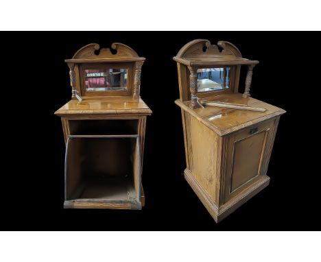 A Victorian Walnut Purdonium, also known as a coal scuttle cabinet or coal hod, top shelf above two turned supports, mirrored