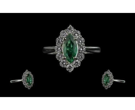 18ct White Gold Navette Ring Set with a Marquise-cut Emerald and Round Brilliant Cut diamonds. Emerald 0.95ct. Diamonds 0.70c