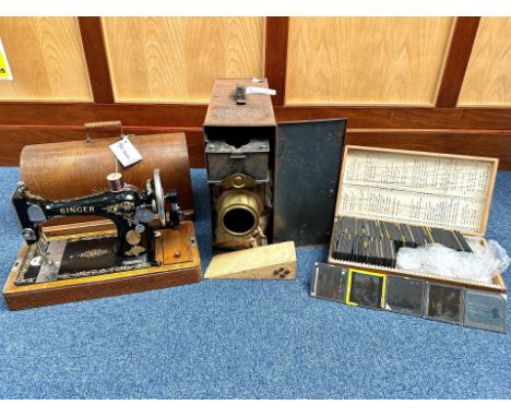 Magic Lantern with a wooden box containing approx. 100 glass slides with religious themes.  Together with a Singer 128 sewing
