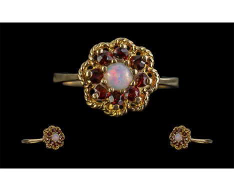 Ladies Attractive and Pleasing 9ct Gold Garnet and Opal Set Ring in a cluster design; tests as 9ct gold, the opals of good co