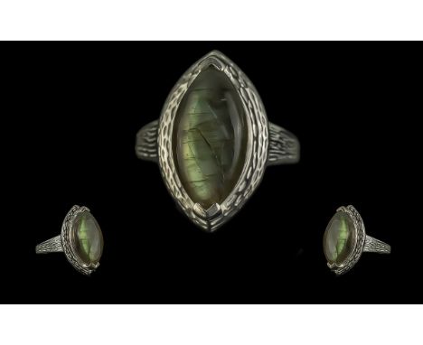 Labradorite Solitaire Ring, the 8.5ct, marquise cut labradorite cabochon showing a wonderful display of inner metallic green 
